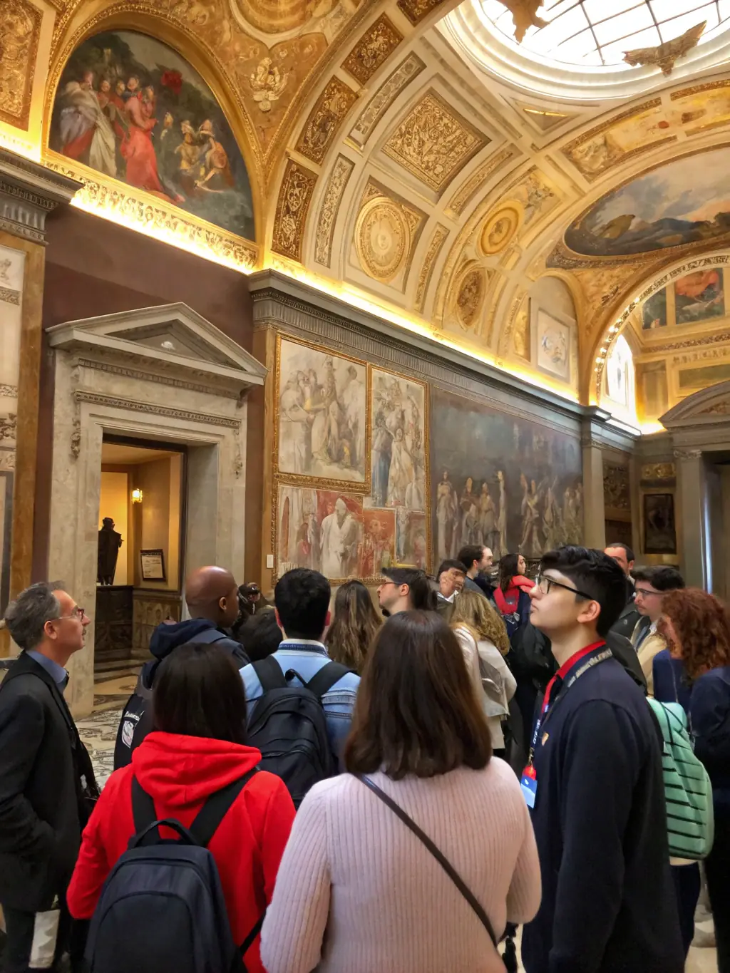 A photo of a guided tour group inside the Abbey, listening attentively to a guide pointing out architectural details and sharing historical anecdotes.